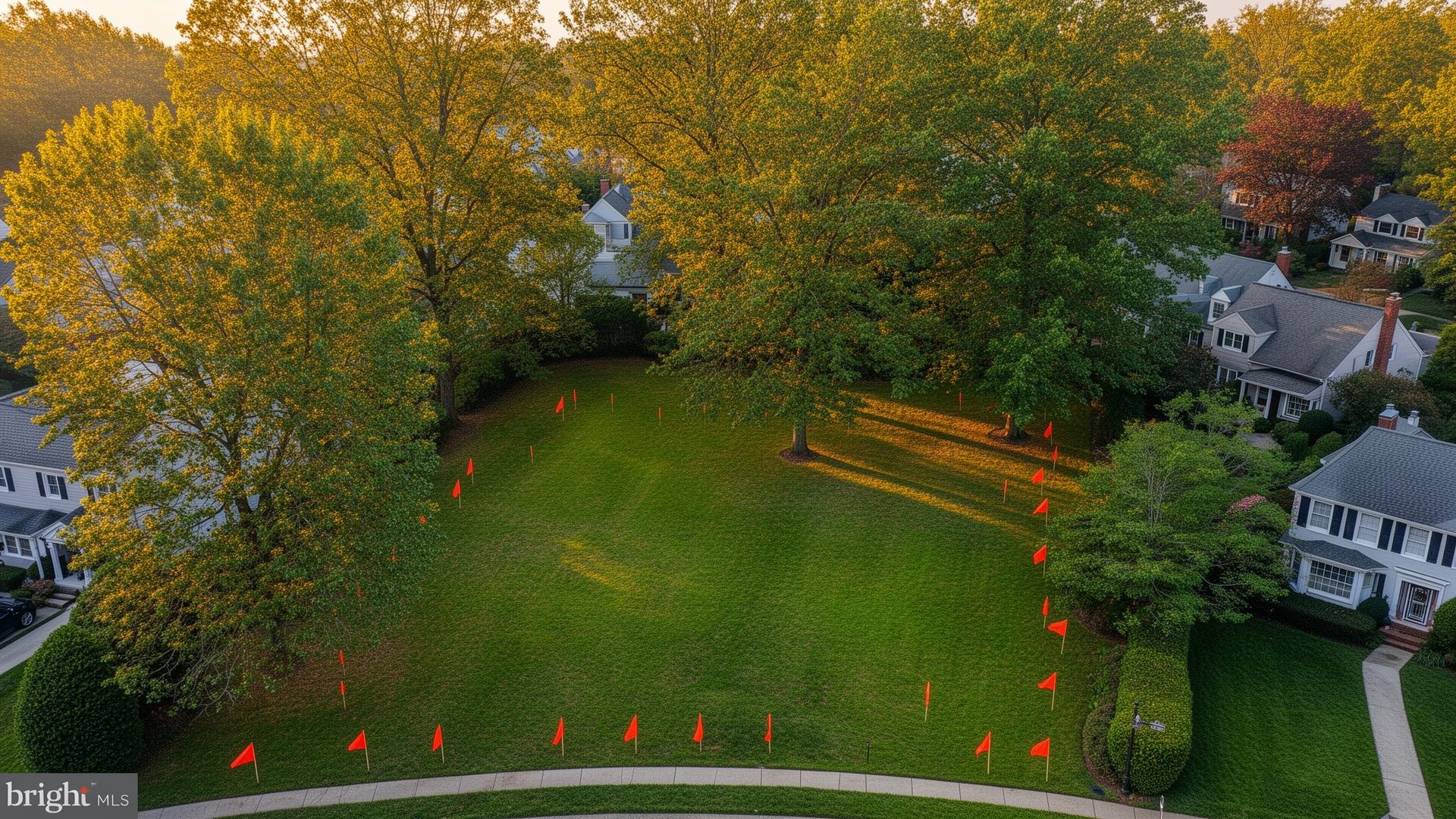 Residential lot in Bethesda Maryland with property boundary survey stakes and mature trees
