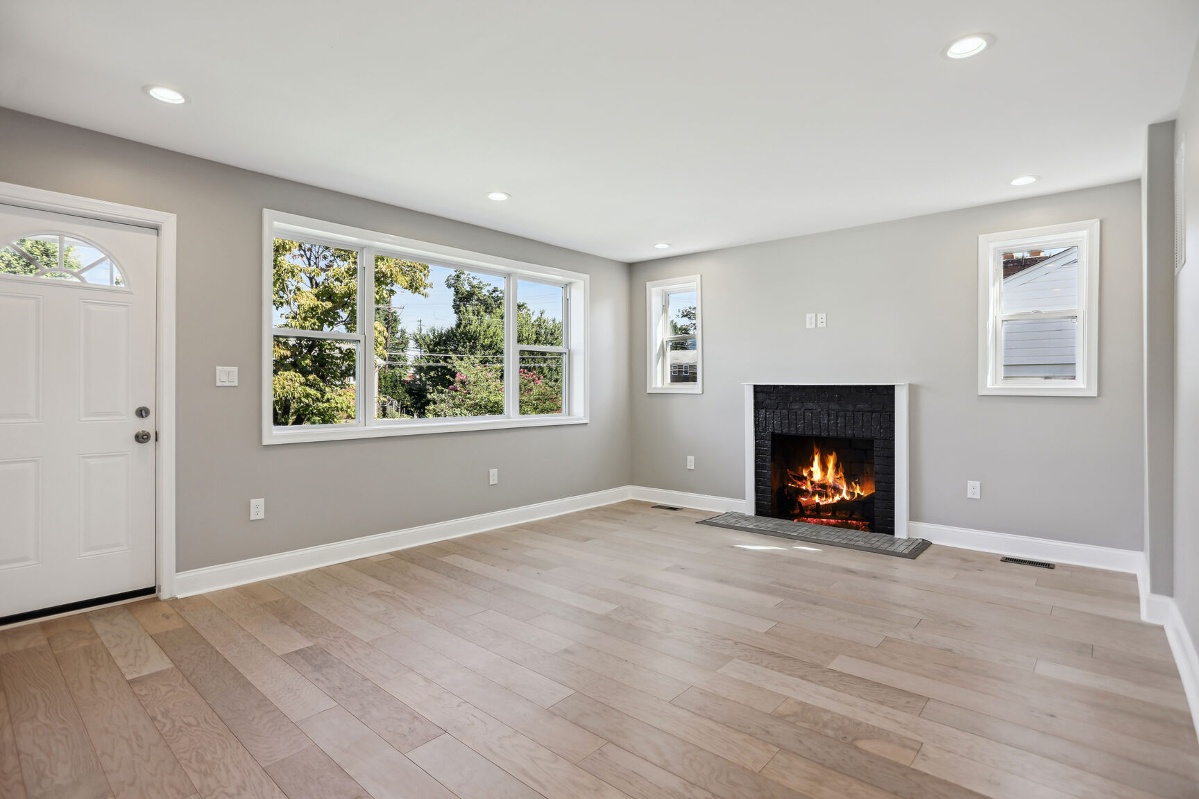 After renovation – modern living room with fireplace, Iron Gate Development flip project DC MD VA