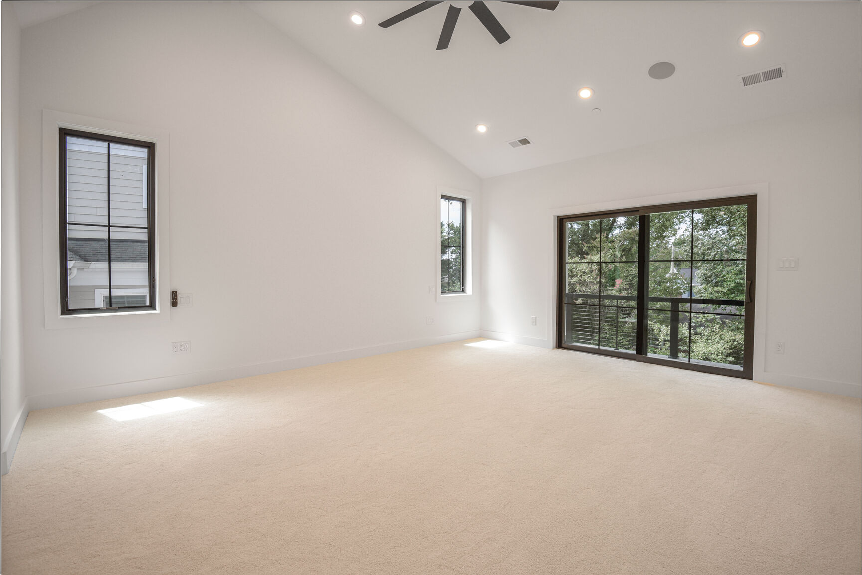Primary bedroom with vaulted ceiling